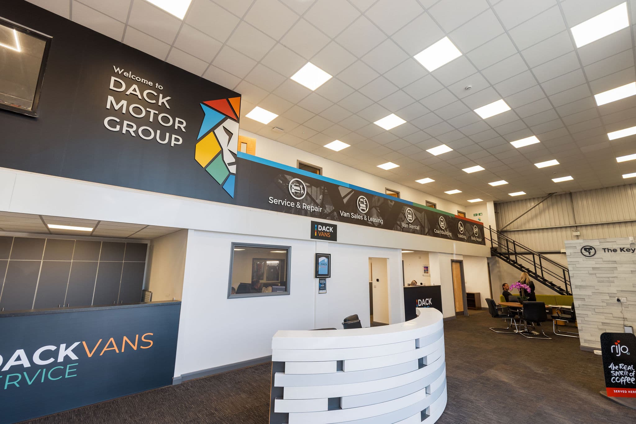 Reception at Dack Motor Group with every department signposted overhead, from service and repair to van rental